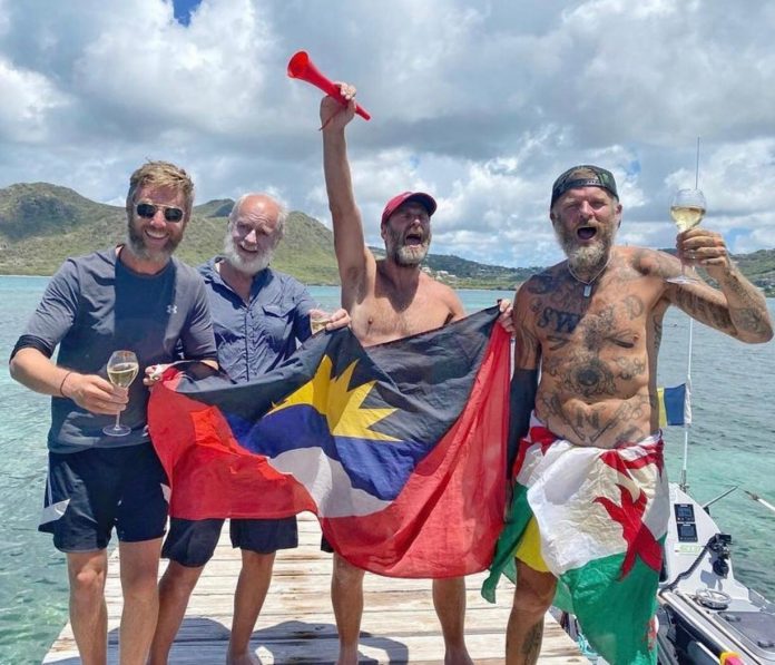 The Herefordshire man celebrates reaching dry land after rowing across the Atlantic

